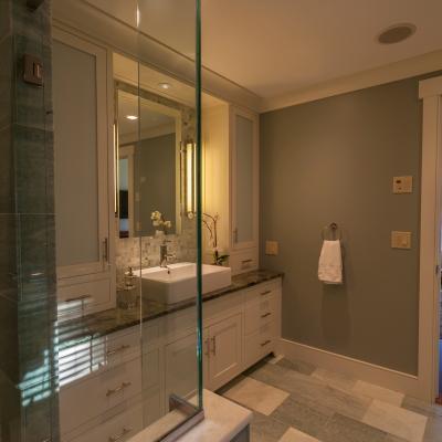 Modern bathroom featuring a glass shower, sink, and elegant decor.