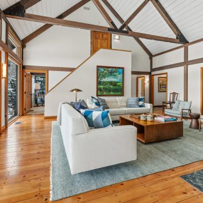 Bright, modern living room with high ceilings, wood accents, and cozy furniture.