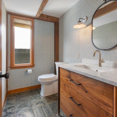 Modern bathroom featuring a wooden vanity, mirror.