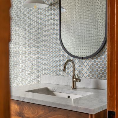 Stylish bathroom featuring a marble sink, vintage-style light.