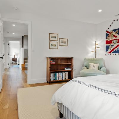 Bright bedroom with a Union Jack wall hanging, sleek furniture, and warm wood accents.