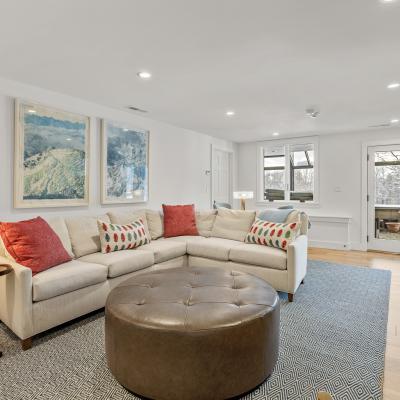 Cozy living room with a sectional sofa, decorative pillows, and large windows.
