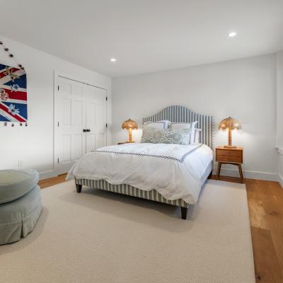 Cozy bedroom with a bed, decorative UK flag wall art, and warm lighting.
