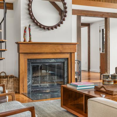 Modern living room with a spiral staircase, fireplace, and stylish furnishings.
