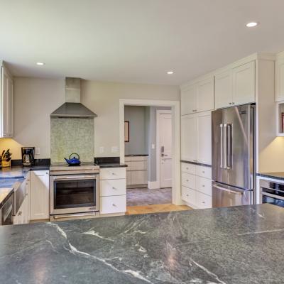 Modern kitchen with sleek cabinets, countertop, and stainless appliances.
