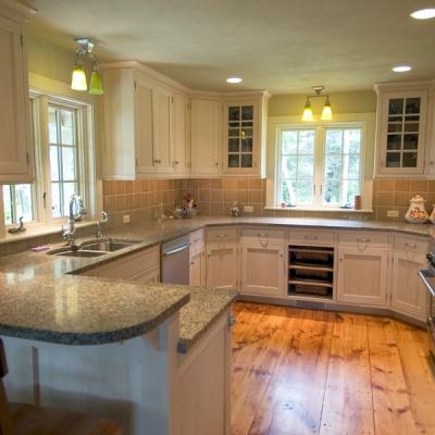 Spacious kitchen with light wood cabinets, granite countertops, and natural light.