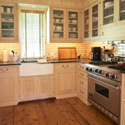 Bright kitchen with wooden cabinets, stainless steel appliances, and a farmhouse sink.