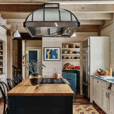 Modern kitchen with wood accents, a large island, and colorful decor.
