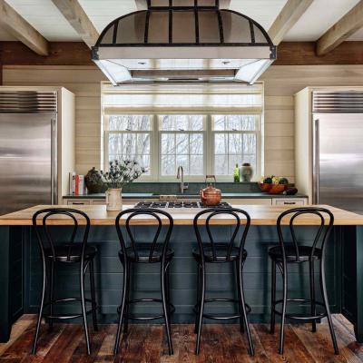 Modern kitchen with a central island, stainless steel appliances, and wooden floor.
