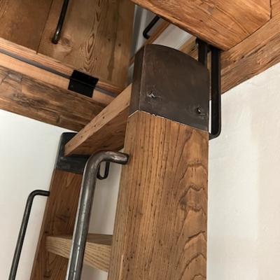 Metal and wood components of a staircase or shelving unit connection.