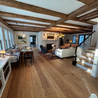 Bright, cozy living space with wooden beams, elegant furniture, and natural light.
