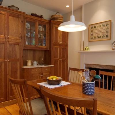 Cozy kitchen with wooden cabinets, a rustic dining table, and decorative elements.