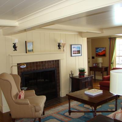 Cozy living room with a fireplace, seating, and colorful decor.