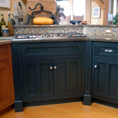Kitchen corner with dark cabinets, a gas stovetop, and decorative tile backsplash.