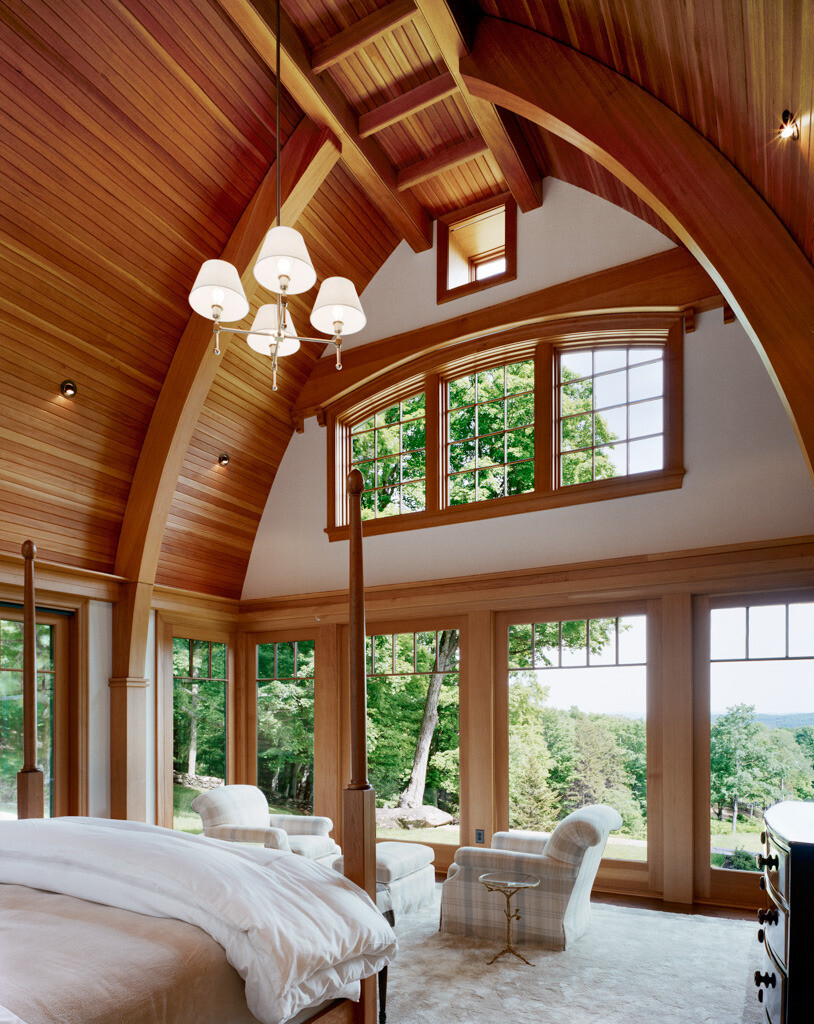 bedroom with large windows overlooking greenery