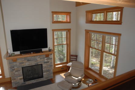 living area with windows and tv