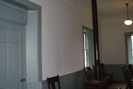 room with windows and chairs