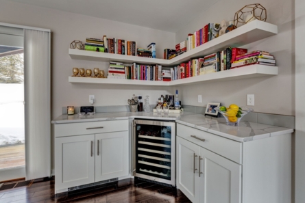 kitchen counter with mini wine cellar and book shelves