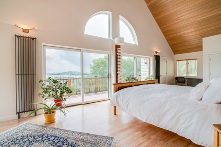 bedroom with large windows and view of vermont